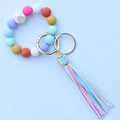 Detail of colorful leopard silicone beads and wooden bead keychain with leather tassel - Rainbow