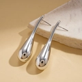 Detail of silver drop-shaped earrings with a polished metallic finish on a textured surface - Silver (Silver Pin) / Silver