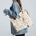 Large canvas tote bag with cartoon bear print and brown straps shown on shoulder - Cute Bear - Khaki