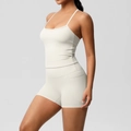 Side view of white yoga set featuring slim fit tank top and high waist shorts with pockets - S / Top And Bottom - Light Ivory