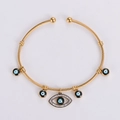 Close-up of golden evil eye cable bracelet with white zircon and enamel pendants - Gold Evil Eye