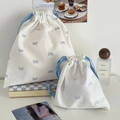 Sweet cream drawstring bags with blue bow prints in small and large sizes for travel - Large / Blue