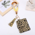 Detail of sunflower pattern black wallet with colorful wood beads wristlet and tassel - Sunflower