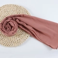 Dusty pink chiffon hijab scarf with beaded details on a rustic straw mat background - 89