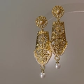 Close-up of vintage gold hollow geometric earrings with delicate pearl drop detail - Gold