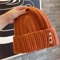 Caramel knitted beanie for women featuring thick ribbed texture and cross embroidery detail - Orange
