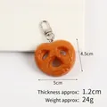 Realistic mini pretzel keychain charm with salt texture and silver metal hook clip - Smiley Hash Brown Lobster Clasp