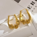 Irregular textured gold hoop earrings with twisted wire design on a white jewelry box - E2294 Gold