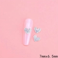 Silver hollow heart nail art charms with rhinestones on pink base, 7mm x 6.5mm size - QFX55-Silver Base Clear Rhinestone Heart (7x6.5mm)