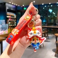 Leuke rode cartoon leeuwendans sleutelhanger met een siliconen band en figuurtje - B444-5 Blauw Stoffen Draak