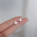 Sterling silver butterfly stud earrings with minimalist hollow design on fingertips - Ethereal Butterfly / Silver