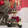Detail of plush snowman ornament with green plaid hat and festive red scarf - Plaid Button Spherical Snowman