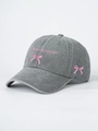 Detail view of pink 'I'm literally just a girl' embroidery on a grey washed baseball cap - Gray