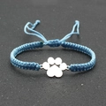Blue braided rope bracelet with silver dog paw charm on a textured background - Sky Blue