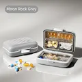 Portable weekly pill organizer in Rock Grey with individual compartments and lids - Moon Rock Grey