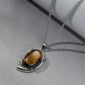 Detail of silver twisted chain necklace with oval tiger eye stone and crystal inlay - Oval Tiger Eye