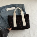 Black corduroy tote bag with strawberry print and white handles in a casual style - Black