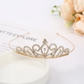 Detail of elegant gold bridal crown with sparkling white rhinestones on a ceramic tray - Crown Style 13
