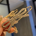 Detailed close-up of a gold bow brooch with sparkling rhinestones held in hand - Golden Full Rhinestone Bowknot Brooch (7.5cm)