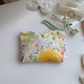 Detailed view of floral cotton mini pouch with zipper and green woven puller strap - Large Yellow Flower