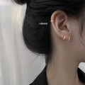 Close-up of stylish 6mm gold geometric hoop earrings and ear cuffs on a model - 6mm - Gold Earrings