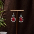 Detail of bohemian silver tassel earrings with red teardrop stone on display stand - Blue Red and Silver (E1141-7)