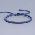Handmade woven Vajra knot bracelet in blue finish with adjustable cord and tassel - Haze Blue