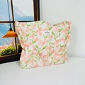 Detailed close-up of a floral canvas tote bag featuring pink flowers and green leaves pattern - Pink Peach Blossoms