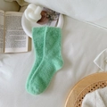 Soft mint green mink cashmere socks for women displayed on a cozy white bed setting - One Size / Lake Green