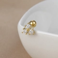 Macro shot of gold-plated stainless steel stud earring featuring three brilliant zircons - Y20437-7 Gold - Triple Drill