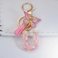 Pink resin letter U keychain with butterfly sequins and pink tassel charm with gold ring - Letter U