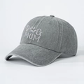 Detailed view of white DOG MOM embroidery on washed dark grey cotton baseball cap - Gray