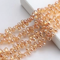 Macro detail of faceted champagne gold teardrop crystal glass beads for jewelry making - 100 Pcs/Pack / Amber Gold