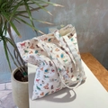 White canvas tote bag featuring colorful cartoon dog patterns and sturdy shoulder straps - Pet Dog