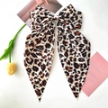 Detail of large leopard print bow hair clip with streamers on a clean background - Khaki Large Leopard