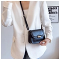Detail of black leather crossbody bag featuring gold twist lock and adjustable strap - Black