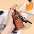 Brown woven leather mini purse with gold zipper and stylish printed silk scarf detail - Tan