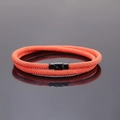Close-up of double-layer orange braided rope bracelet featuring a black magnetic clasp - Orange