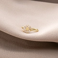 U-shaped gold flower ear cuff with marquise-cut clear crystals on beige fabric - Hollow Flower (E3475)