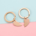 Close-up of split heart-shaped keychain set in rose gold finish with two complementary halves - Rose Gold Set