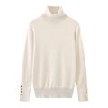 Close-up of decorative gold buttons on the cuffs of a beige turtleneck knit sweater - Off White