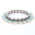 Detail view of 9mm modular stainless steel link bracelet with cartoon animal charms - 0024-blue Background With Small Pink Circles And Gold Trim 1 Section