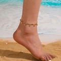 Minimalist gold stainless steel anklet with sparkling cubic zirconia on a beach model - Gold Zirconia Anklet
