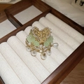 Detailed close-up of golden hair pin with green flowers and teardrop pearl tassels - Pearl Cluster Floral Hoop / Gold
