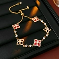 Macro detail of gold adjustable bracelet with red shell four-leaf clover zircon charms - Bracelet-Gold-Red
