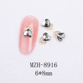 Macro shot of 6x8mm heart-shaped grey cat eye nail art charm with gold rhinestones - Gold Heart Style With Grey Crystal (8916)