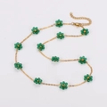 Minimalist gold necklace featuring small green crystal daisy charms and lobster clasp - Green