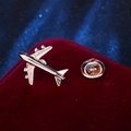 Classic gold metal airplane brooch pin accessory displayed on red velvet padding - Gold Airliner