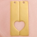 Detail of golden stainless steel rectangular pendants forming a hollow heart on pink fabric - Gold (One Set)