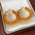 Macro detail of 24k gold plated mesh textured hoop earrings on premium velvet box - Gold